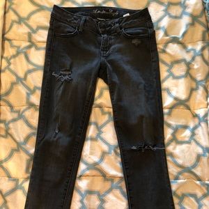 Distressed black skinny jeans